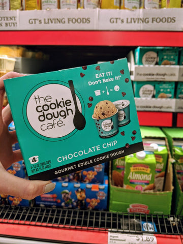 Hand holding a box of Cookie Dough Café Minis in an Aldi aisle