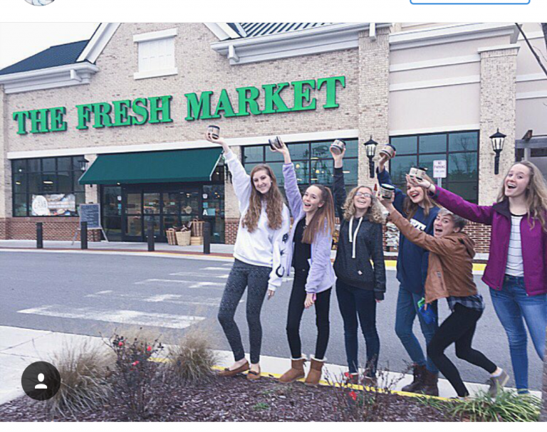 The Cookie Dough Café team celebrating outside of The Fresh Market