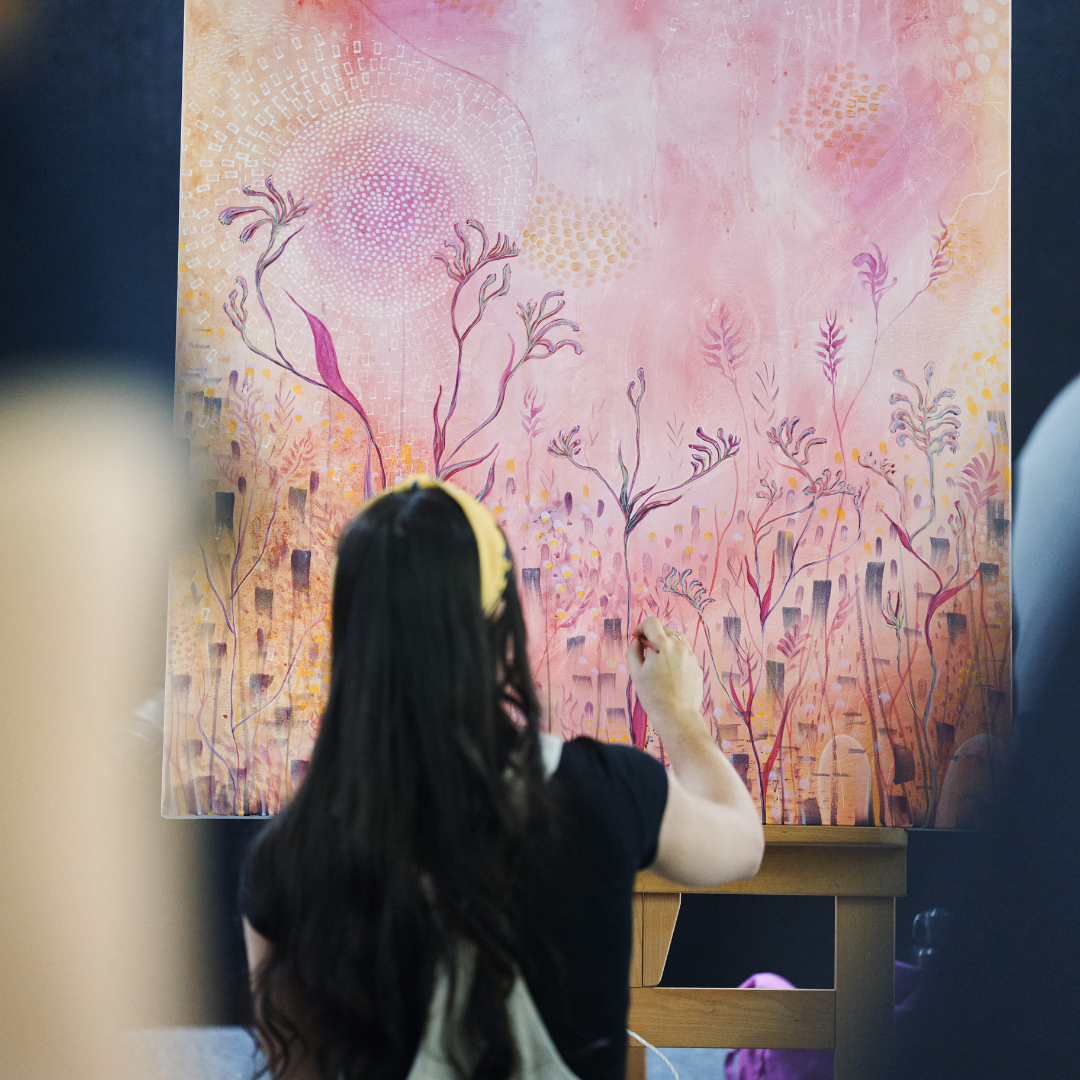 Artist painting on an easel.