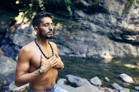 a man meditating by the river