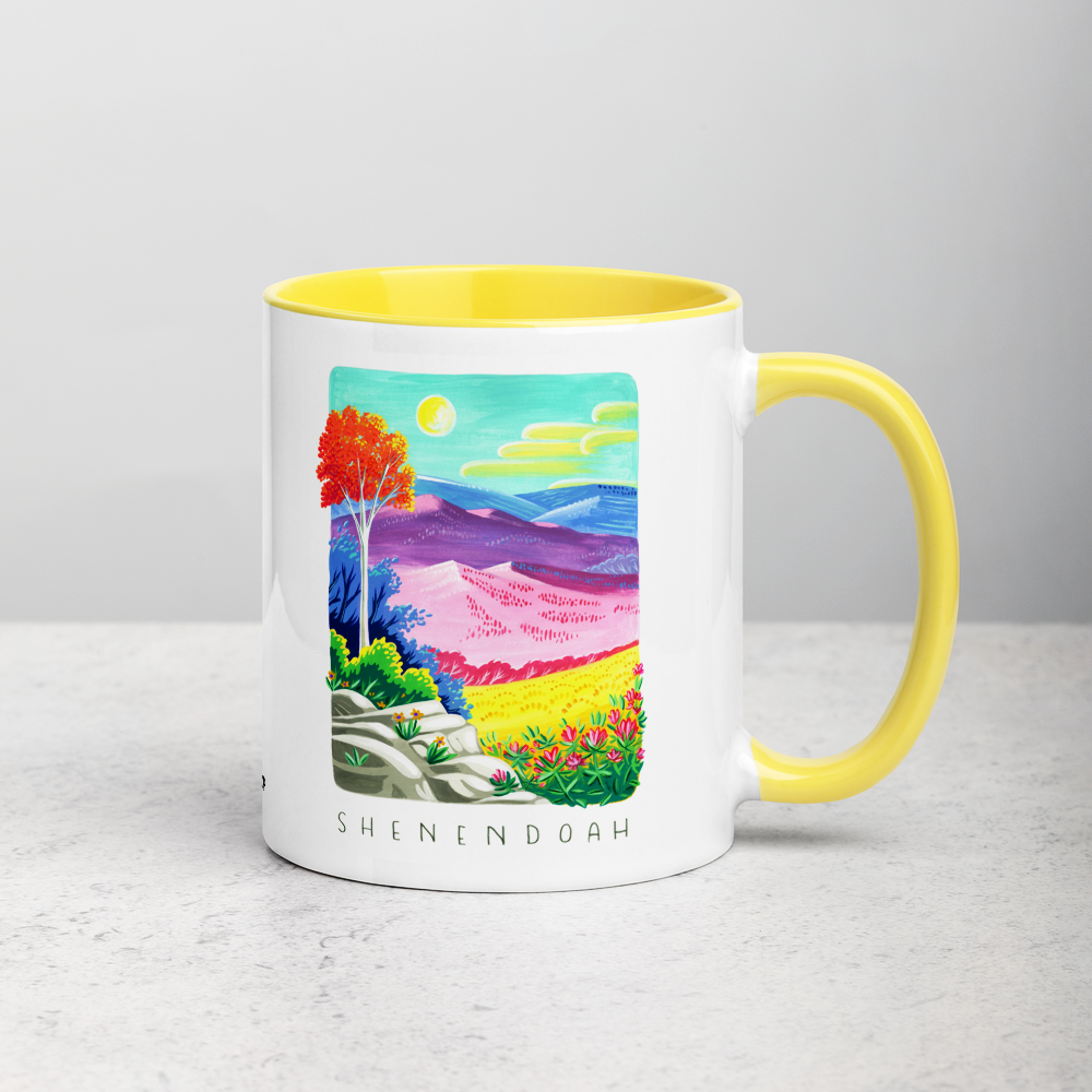 White ceramic coffee mug with yellow handle and inside; has Shenandoah National Park illustration by Angela Staehling