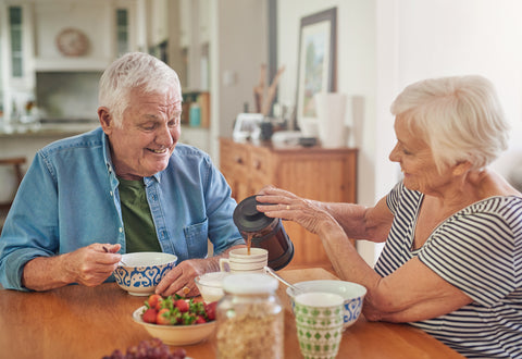 Elderly couple enjoying breakfast