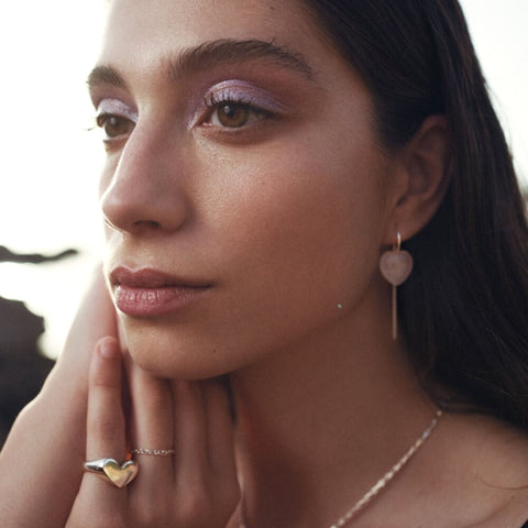 Model wearing rose quartz silver statement earrings