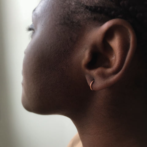 Model wearing PHASE Fine hoop earrings in rose gold