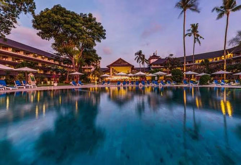 Swimming pool in evening at Kuta Kartika Plaza Discovery Resort, Bali Indonesia 