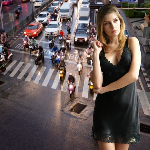 Woman in black slip stand near busy Bangkok city intersection 
