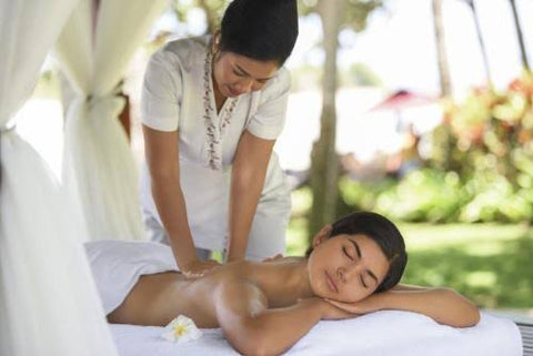 Woman enjoying spa massage outside at Laguna Resort, Bali Indonesia 