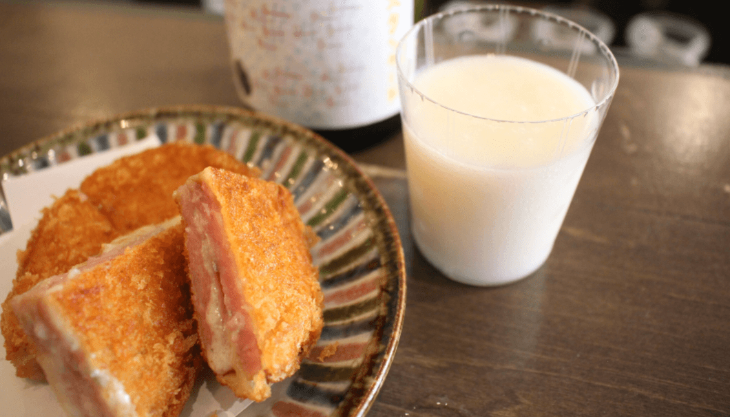 A melty ham and cheese breaded and fried cutlet with a nice cool glass of doburoku, which acts like a tangy sauce on the palate.