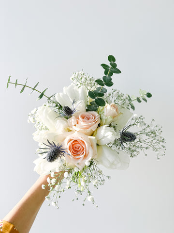 Bouquet of roses, tulips, babys breath, sea holly and eucalyptus