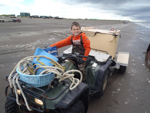 Fisher on ATV bike delivering sockeye salmon to processor