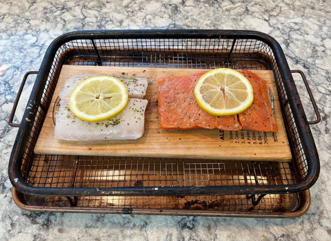 wild salmon on alder grilling planks with lemon and seasoning and salt taste better than on cedar planks