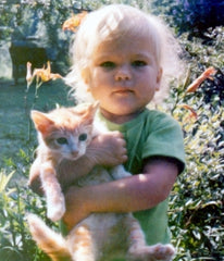 Toddler Jane holding an orange cat