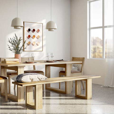 Wooden dining table and bench seat with sun coming in window