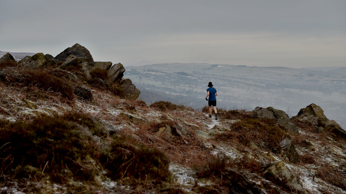 Trail runner on a UK hilltop in overcast weather