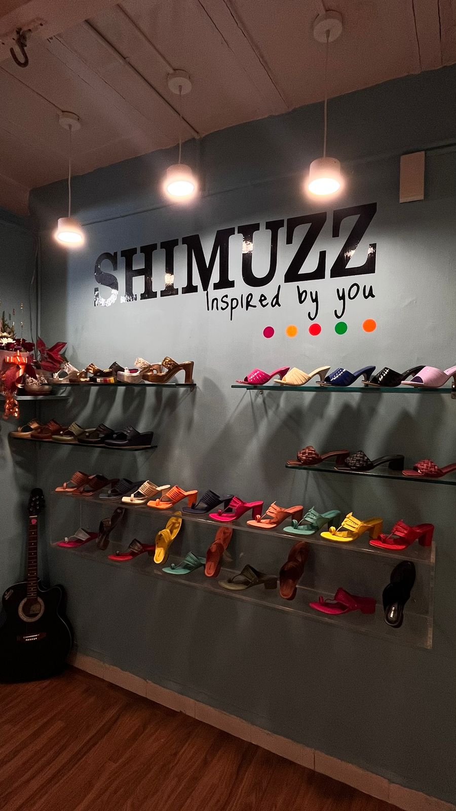 SHIMUZZ Store interior with Vibrant footwear kept on the shelves as display.