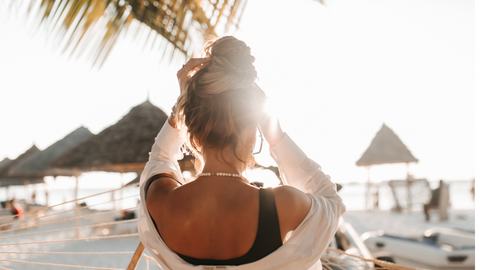 women on the beach with sun