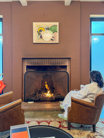 woman sitting in front of fireplace