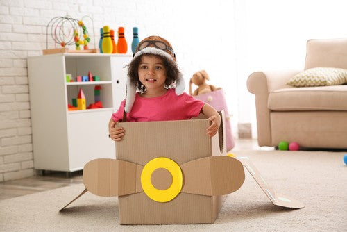 Kid in a cardboard box airplane