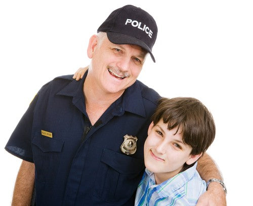Kid hugs a police officer smiling