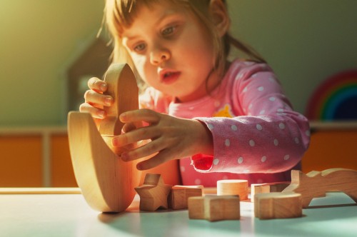Toddler plays with blocks