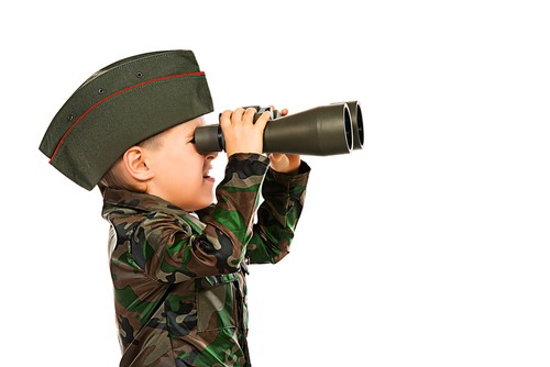 Soldier kid looking through binoculars