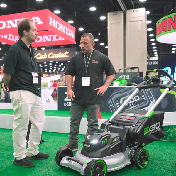 Vince Carneglia examines the new EGO Professional walk-behind mower with an aluminum deck at the Equipment Show 2023, showcasing the latest in lawn care innovation