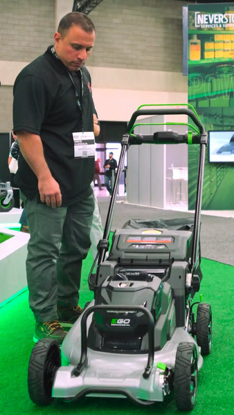Vince Carneglia from VCG Construction looks over the new EGO Professional walk-behind mower, highlighting its robust aluminum deck and advanced design