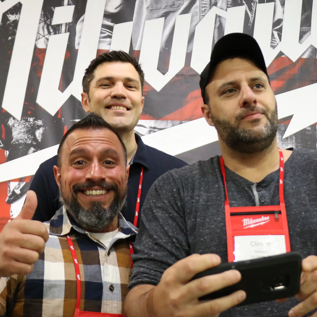 Three industry pros at Milwaukee NPS 2019 event, giving thumbs up before a branded backdrop, embodying professional community spirit.