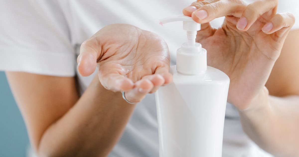 Close up of a woman using body lotion
