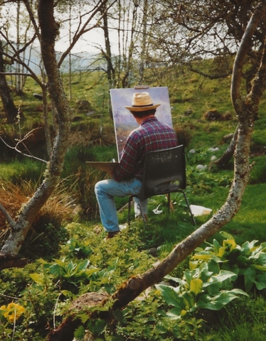 Howard Butterworth sits painting his famous silver birches and daffodils as an oil painting in is glen muick garden in the Cairngorms