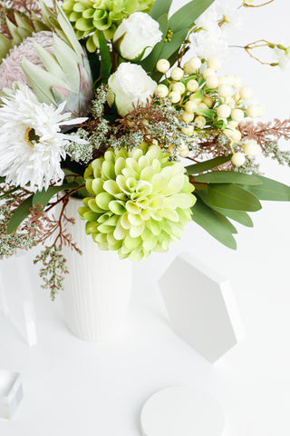 Green bouquet in a vase is perfect for your dinner table