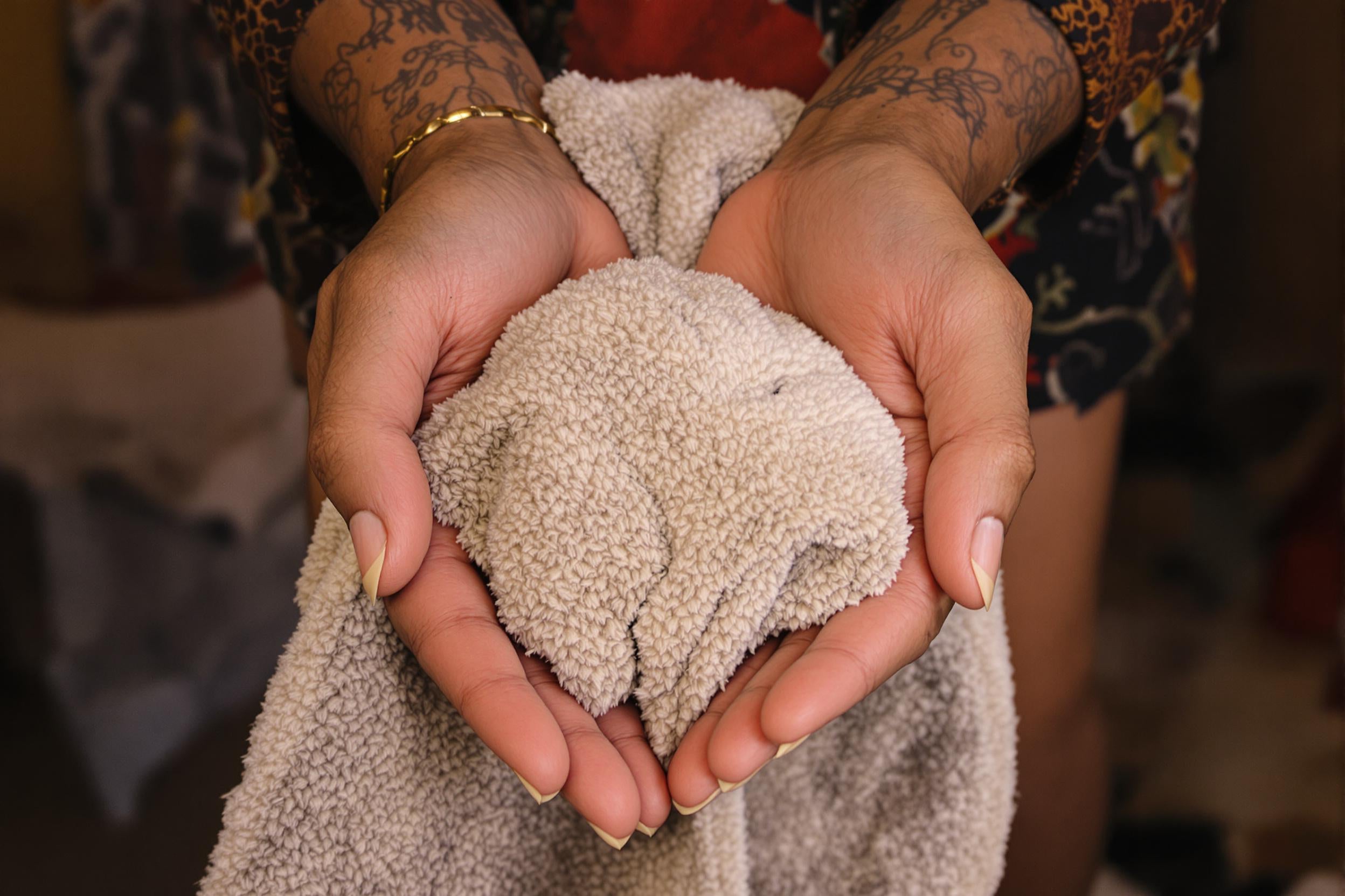 Hands holding a warm towel