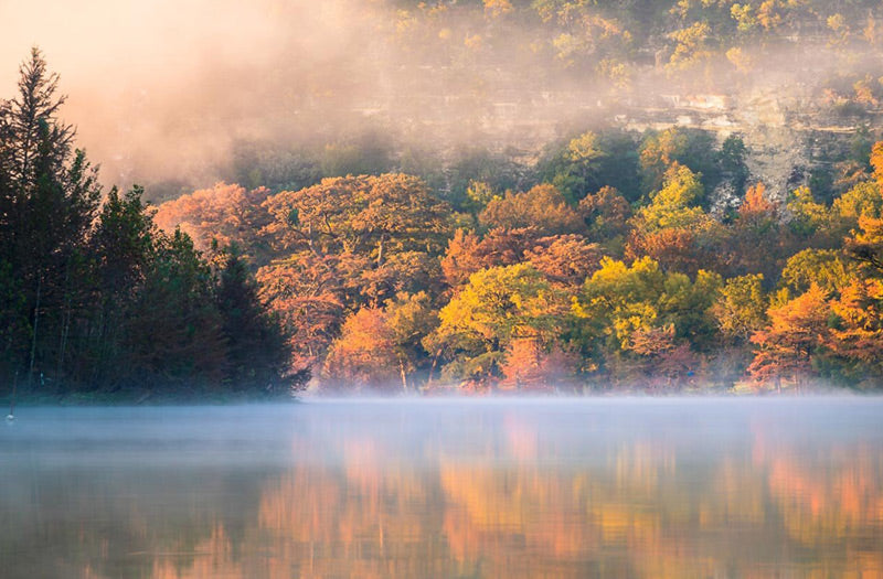 Morning mist lingers in the air, the sun illuminates the hillside. No, this isn't Vermont — it’s the Frio River at Garner State Park.