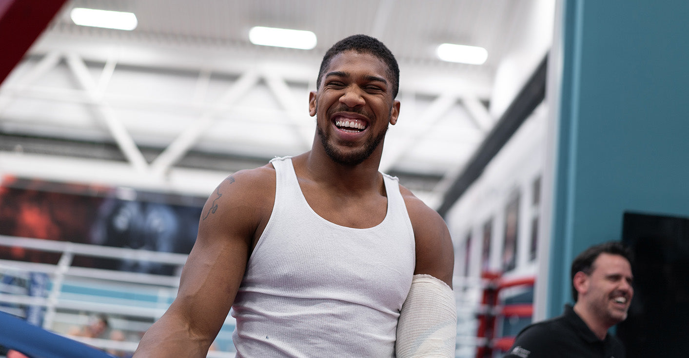 AJ smiling whilst training in the gym