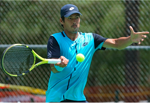 Jason Kubler hitting tennis ball with tennis racket. 