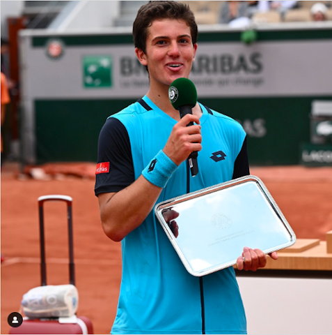 Gilles Arnaud Bailly holding trophy plate from 2022 French Open 