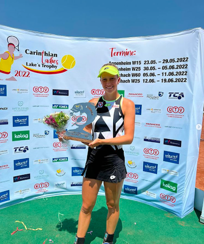 Sinja Kraus holding flowers and trophies 