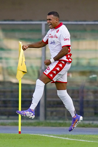 Walid Cheddira jumping in the air in celebration 