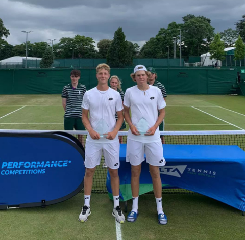 Martin Landaluce and Alex Michelsen tolding trophies 