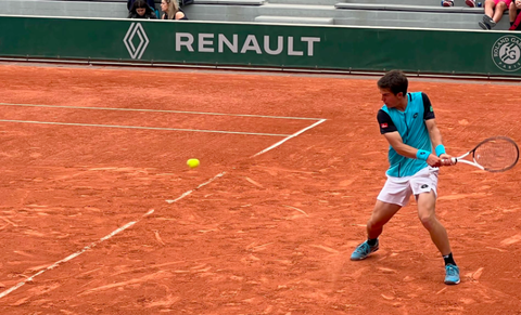 Gilles Arnaud Bailly hitting tennis ball.