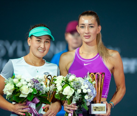 Kamilla Rakhimova and Yana Sizikova holding flowers and trophies after winning second place at the 250 WTA Transylvania Open Tournamen