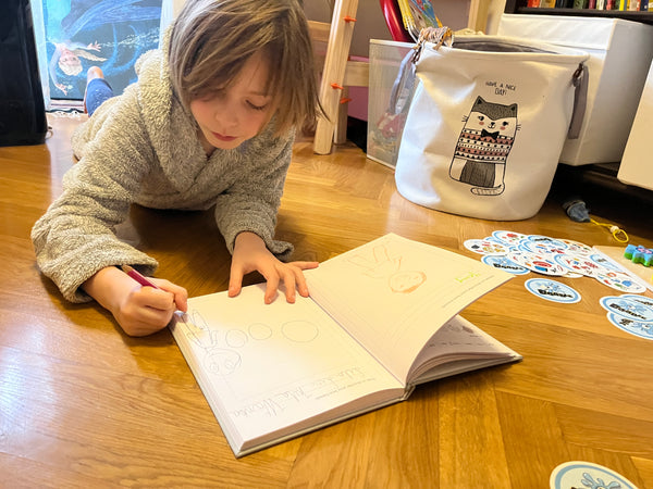 Girl lying on the floor and writing a journal