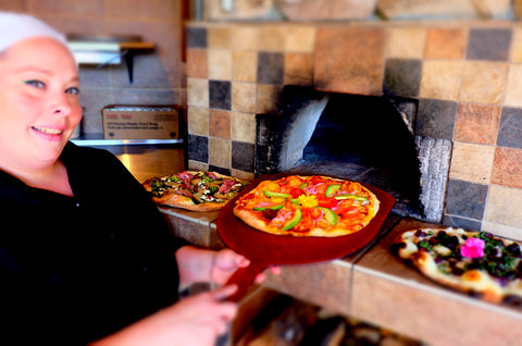 Jenn firing a pizza