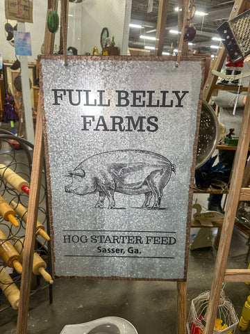 Metal farm sign that has image of a pig and says "Fully Belly Farms"