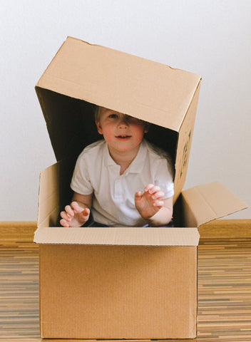 Imaginative play with a cardboard box