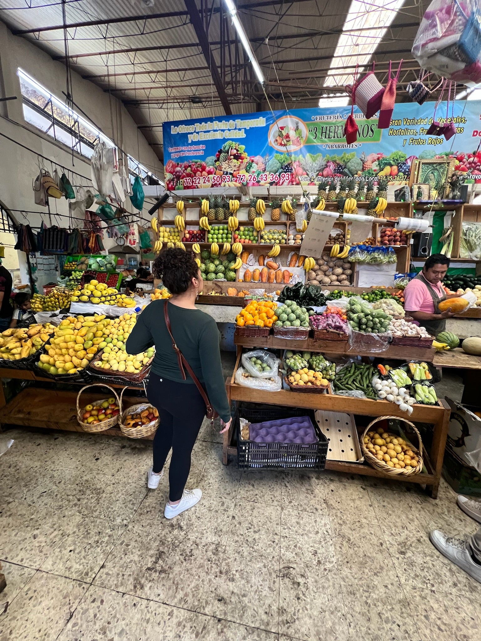 Woman in front of fruit stand in Mexico