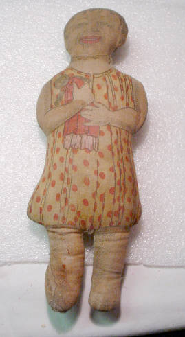 This doll, a cut-out and sew cloth doll, is the daughter of the fictional character Aunt Jemima. "Diana Jemima" is written near the bottom of her backside. Aunt Jemima and her family, which in addition to Diana included Moses and Wade, were an advertising scheme by the R.T. Davis Mill Co. of St. Joseph Missouri. The dolls could be obtained by sending one box top from a flour package and 24 cents in stamps. Advertising with cloth dolls became very popular between 1890-1942. Courtesy University of Illinois at Urbana-Champaign, University Library