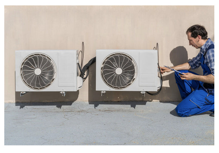 A worker doing the aircond maintenance