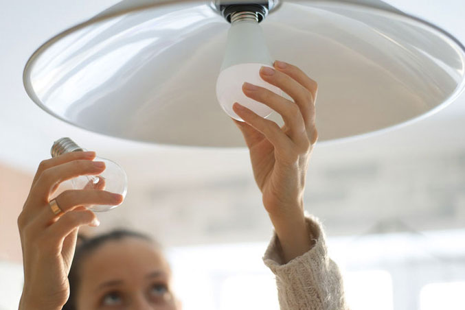 A lady changing the LED light bulb