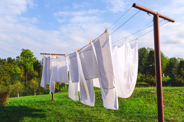 Fresh clean white sheet drying on washing line in outdoor